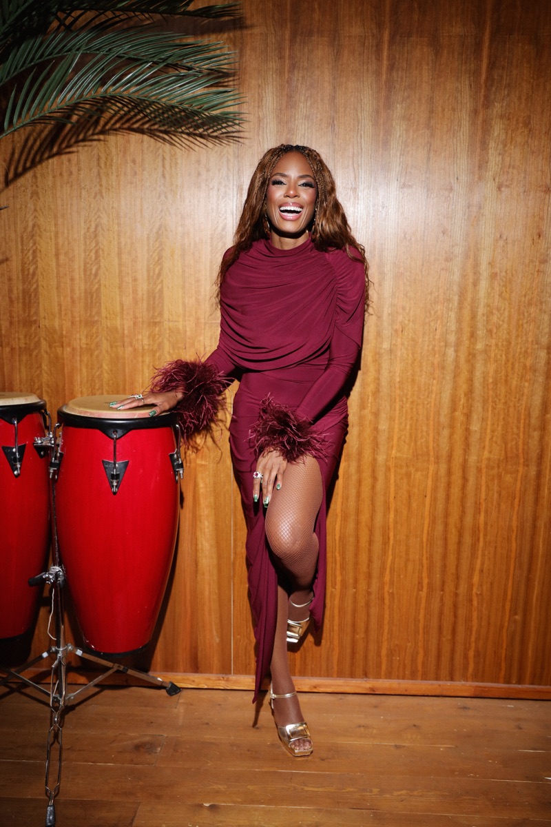 Yulanda performing live in a burgundy dress